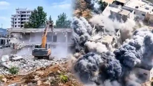 Bulldozer demolishing residential home