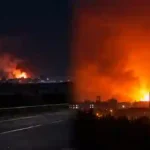 Ukraine Frontline Shifts: Massive fireballs and smoke rising over city buildings and highway at night following airstrikes