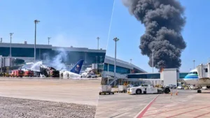 Riyadh airport attack showing damaged commercial aircraft on the tarmac with emergency response units and smoke plume
