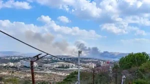 Smoke rising over hillside village